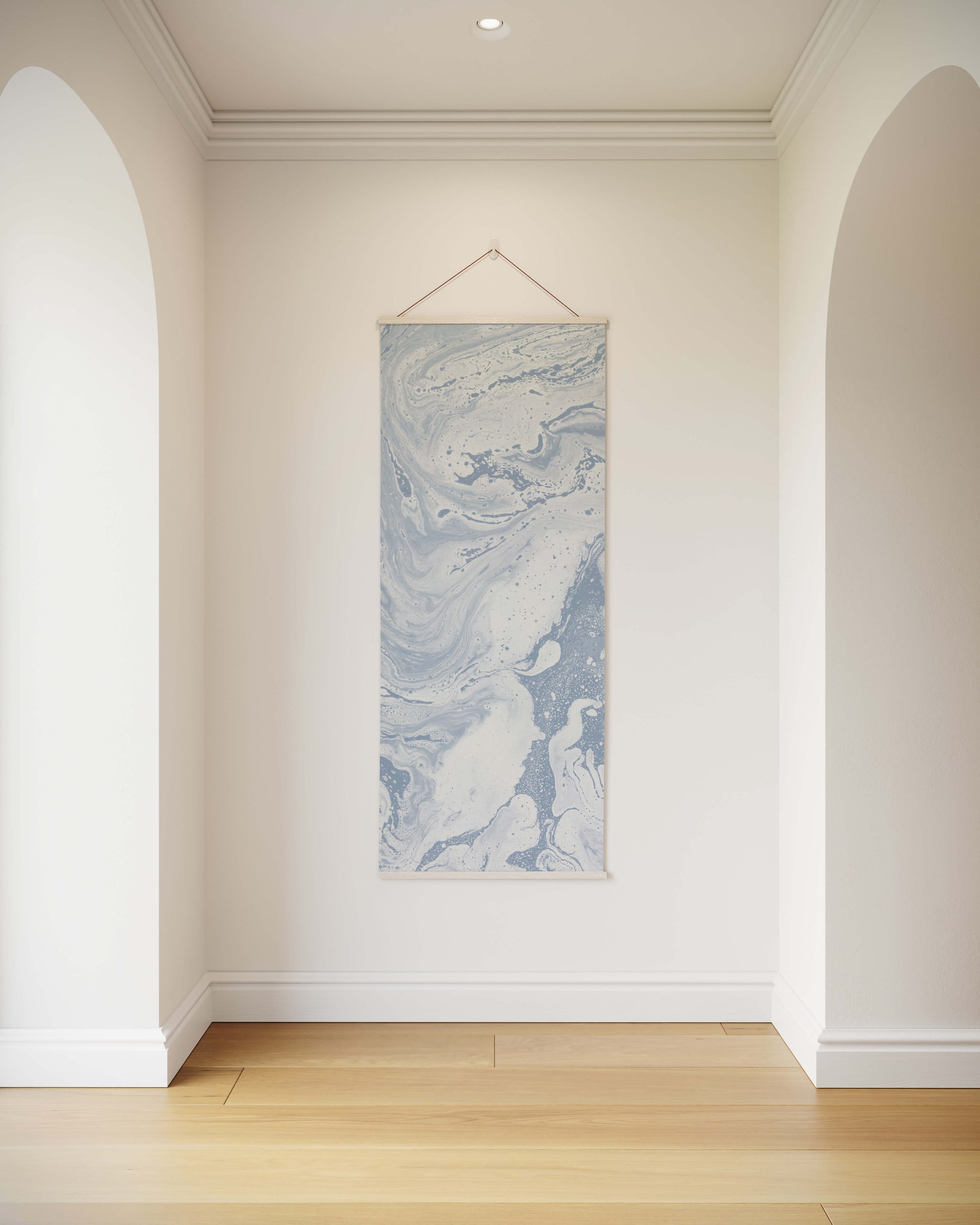 Marble-patterned wall art hanging on a white wall in a room with wooden flooring.