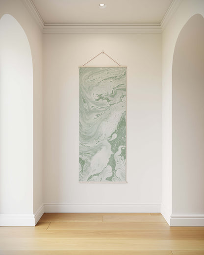 Marble-patterned wall art hanging on a white wall in a room with wooden flooring.